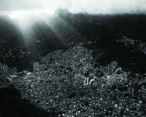 Shafts of sun break through the clouds over the crowded Brazilian Rocinha favela shanty town in Rio de Janeiro Brazil