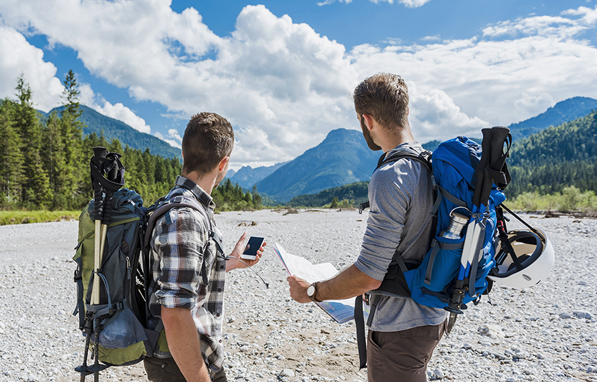 Backpackers with phone and map